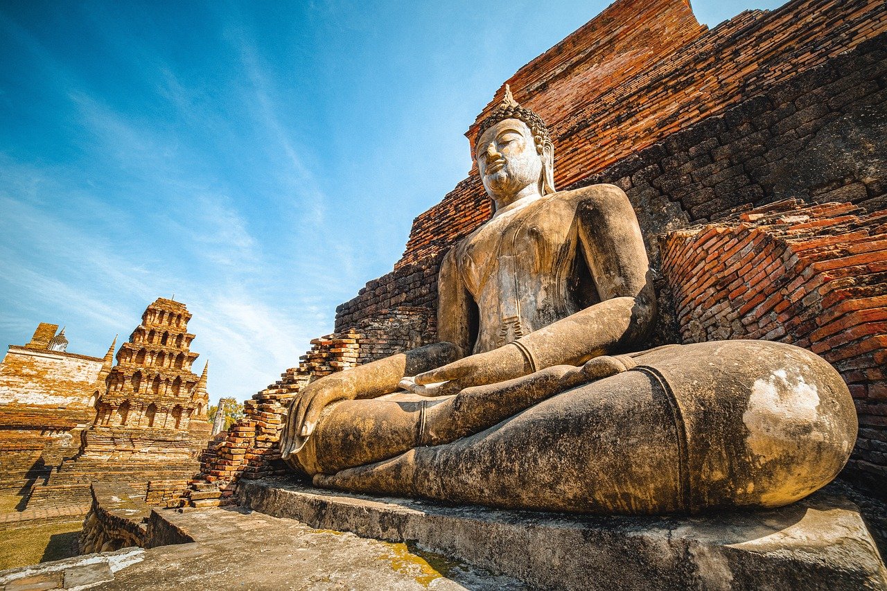 Thailand historical ruins at sunset with ancient stone chedis