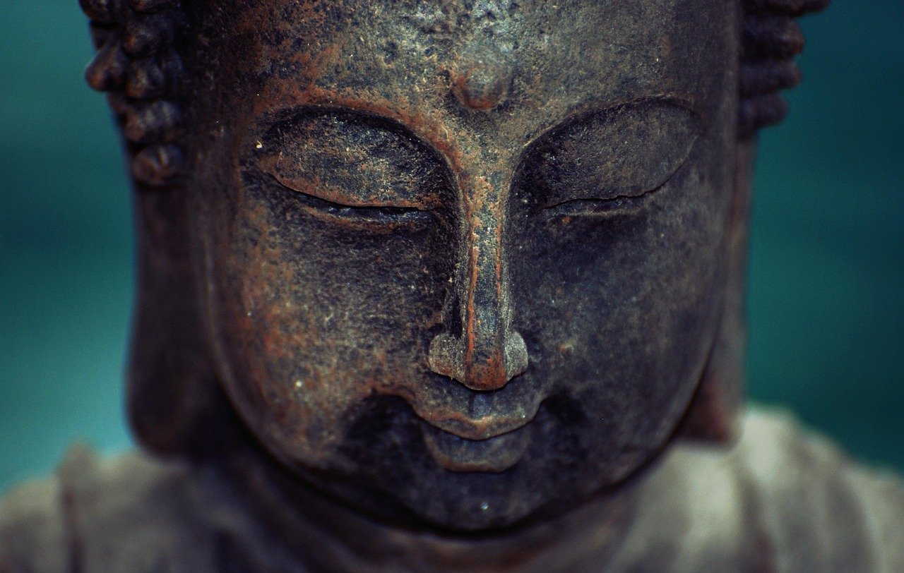 Zen Buddha meditation sculpture peaceful garden setting
