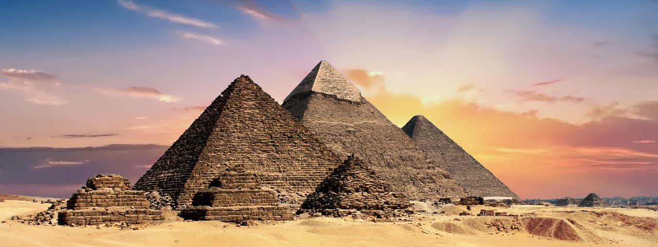 Giza pyramids panorama at sunset over the Egyptian desert