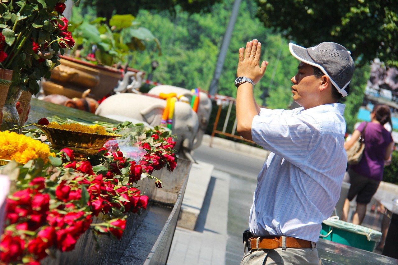 Bangkok Thailand shrine golden offerings garlands flowers incense