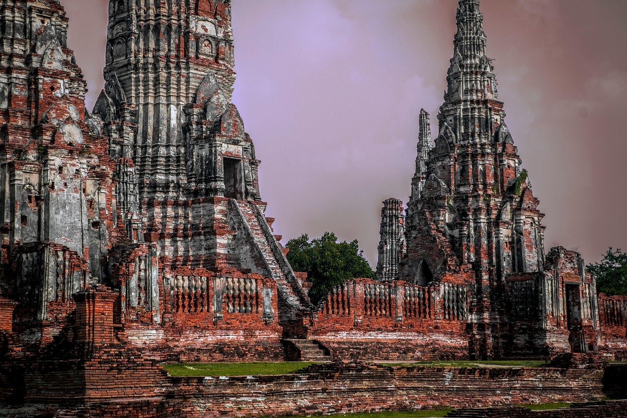 Ancient Ayutthaya ruins with broken sandstone chedis and temple structures Thailand