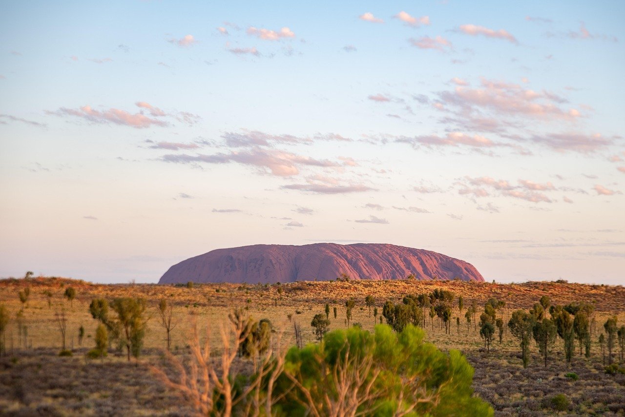 Uluru changing colours at sunset golden hour Australian desert