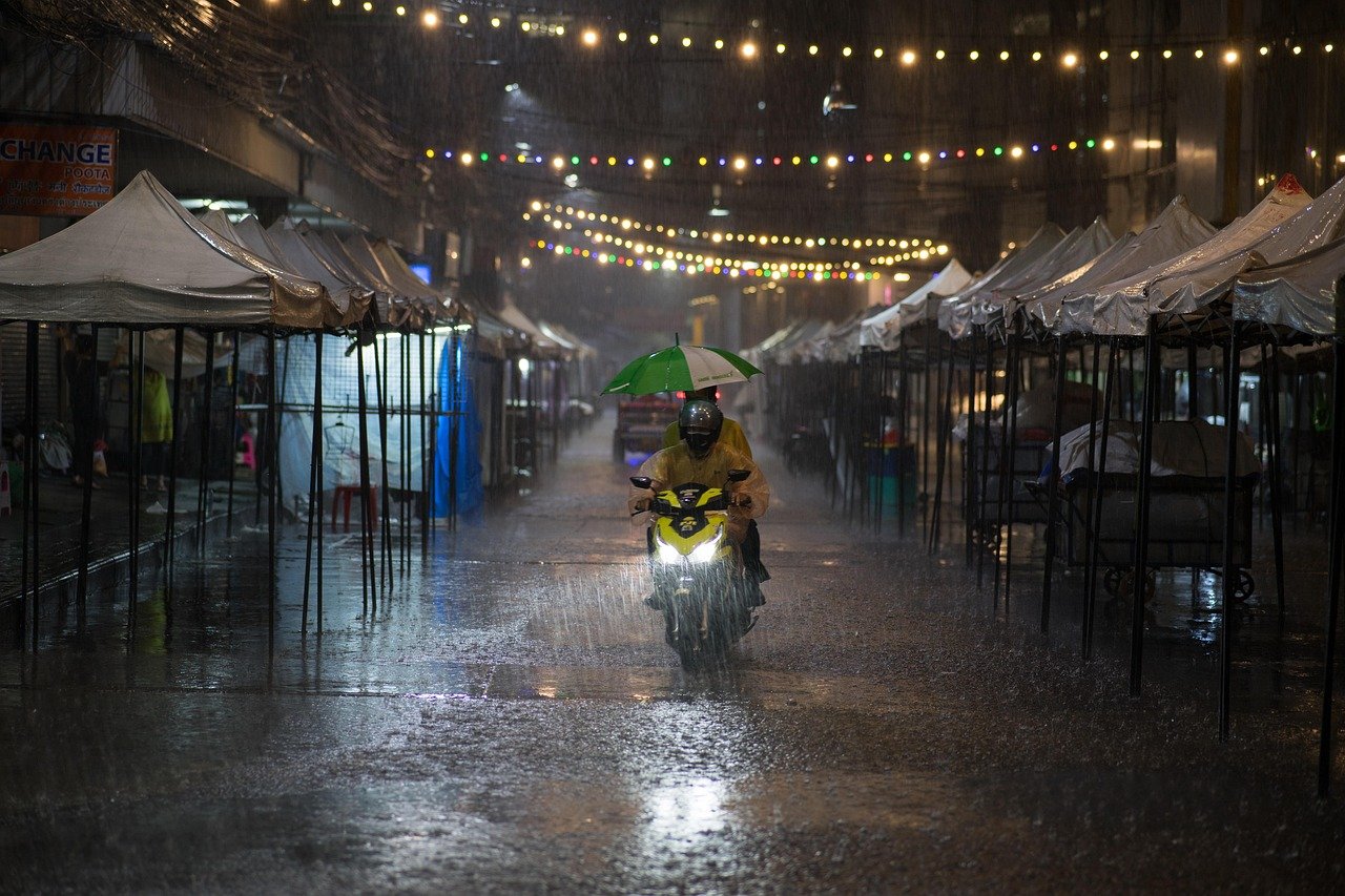 Bangkok night market atmosphere rainy street evening