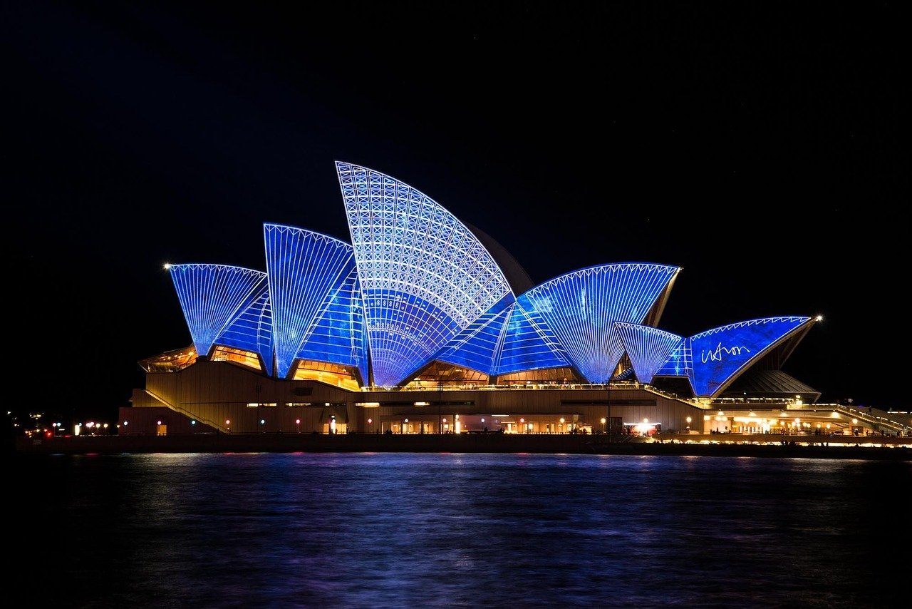 The iconic white shell-shaped roofs of the Sydney Opera House against Sydney Harbour